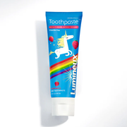 Kids unicorn toothpaste tube, blue with rainbow stripes and unicorn graphic.