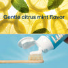 Lumineux® whitening toothpaste squeezing onto toothbrush with blue-and-white mint foam